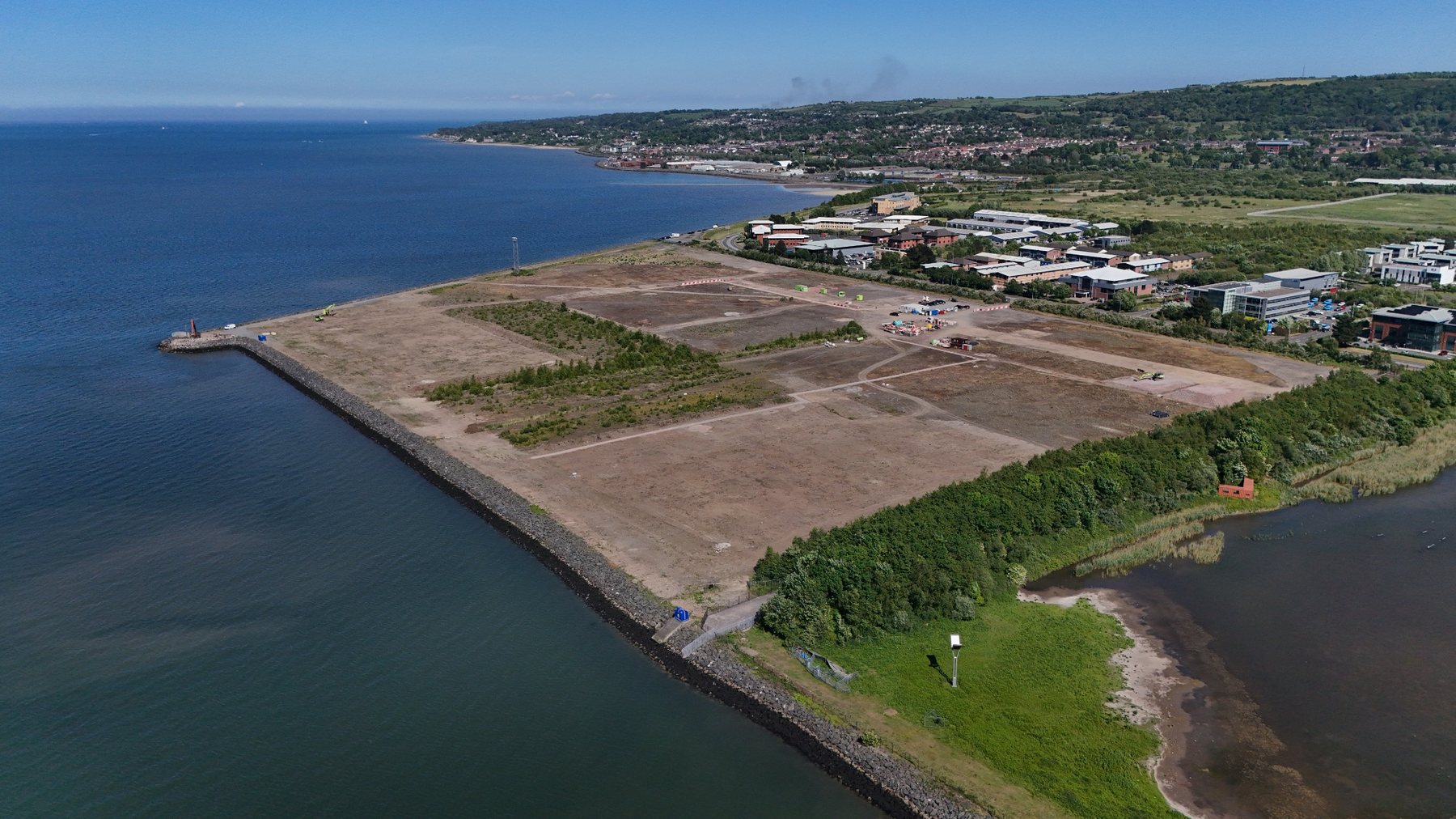 Wide aerial photograph of a large waterfront development site