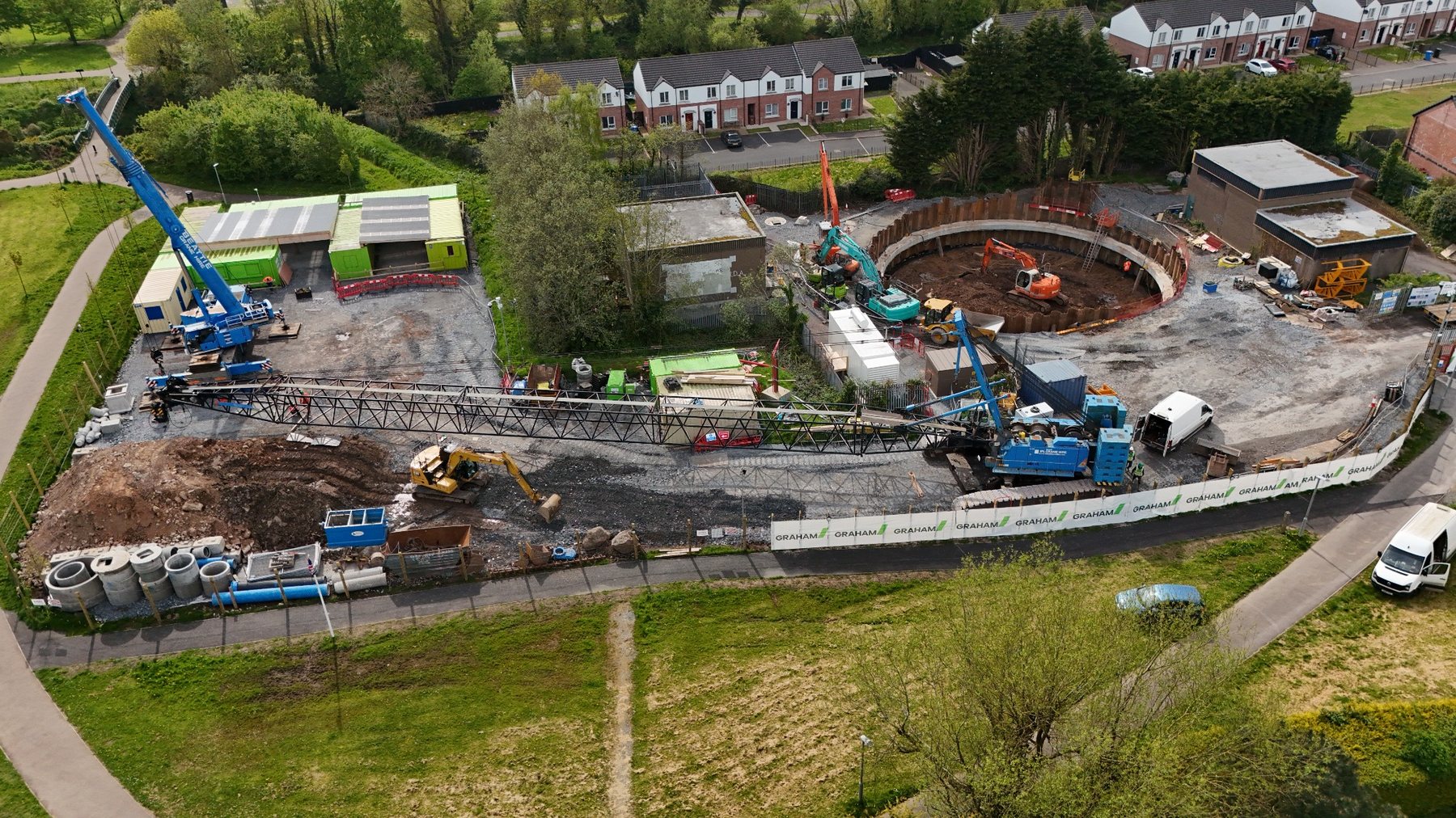 Aerial photograph of an active construction site with cranes and circular excavation